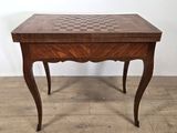 an image of a wooden table with a chess board on it