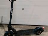 a scooter that is parked in front of a garage door
