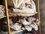 a room with a ladder that has a lot of blankets on it
