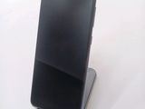 a cell phone that is sitting on top of a stand