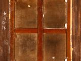 a window with some writing on it in a wooden frame