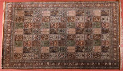 an antique persian rug with a multicolored design on a pink background