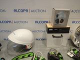 a helmet, earphones, and other items on a table