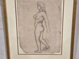 drawing of a nude woman in a gold frame hanging on a wall