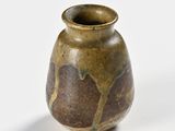 a small vase with a brown and black design on it