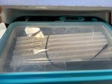 a plastic container with a bunch of hotdogs inside of it