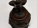 a small wooden box with a bird on top of it