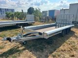 the trailer is parked in a field with other trailers in the background