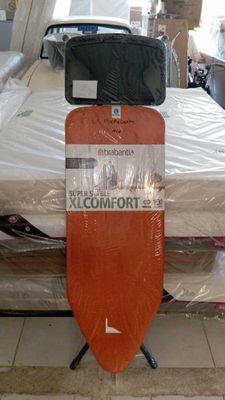 a surfboard that is sitting on top of a bed