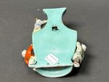 a blue vase with shells on it sitting on a table