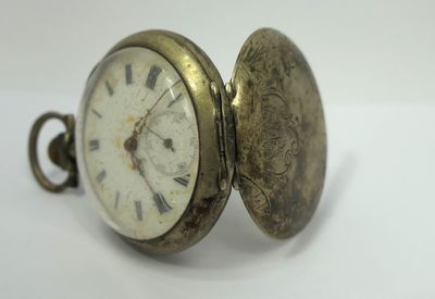 a close up of a pocket watch with roman numerals on it