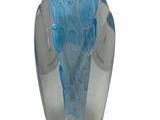 a blue glass vase sitting on top of a white surface