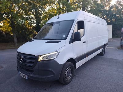 the white van is parked in a parking lot with trees in the background