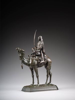 an image of a bronze statue of a man on a camel