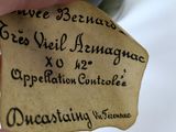 a hand holding a piece of paper with writing on it