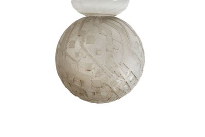 a white bird sitting on top of a white ball