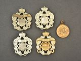 four different types of badges and a coin on a table