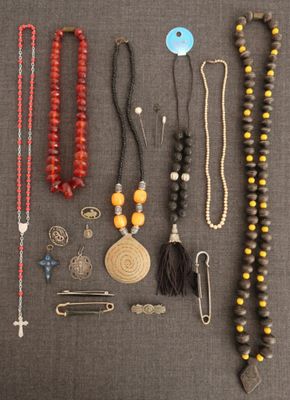 a bunch of beads and necklaces laid out on a table