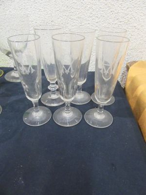 six verres à vin posés sur une table recouverte d'une nappe bleue