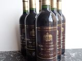 several bottles of wine are lined up on a table