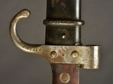a close up of a sword with a metal handle