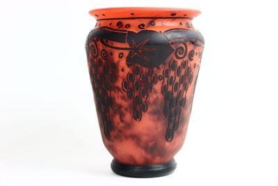 a red vase with black designs on it on a white background