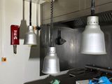 three lamps hanging from the ceiling in a kitchen