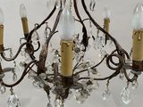 a chandelier that has five lights hanging from it