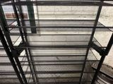 a metal shelf that has a lot of shelves on it