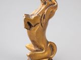an image of a gold statue of a cat on a pedestal