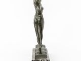 a bronze statue of a woman standing on a marble base