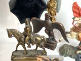 a statue of a man riding on a horse next to a clock