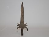 an old knife with a long blade sticking out of it ' s side