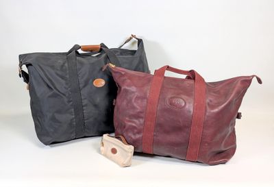 two bags sitting next to each other on a white surface