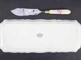 a white tray with a knife on top of it