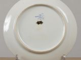a white plate with a blue design on it on a table