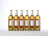 four bottles of wine are lined up on a table