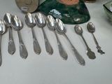 a lot of silver spoons and spoon spoons on a table