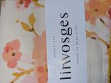 a label on a bed sheet with a floral pattern