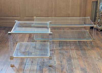 a glass coffee table that is on a wooden floor