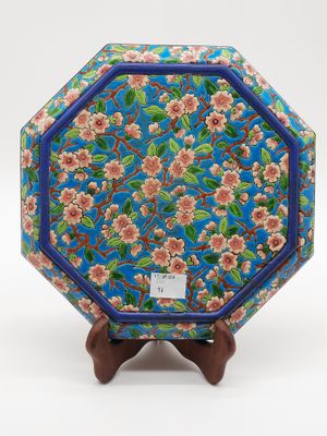 une image représentant une assiette bleue et rose ornée de fleurs