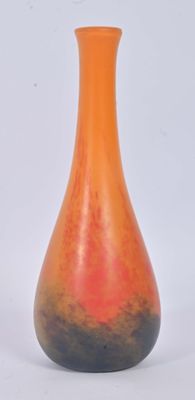 an orange and black vase sitting on a white surface