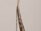 a long horn with a chain hanging from it ' s end