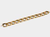 a close up of a gold chain bracelet on a white background