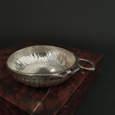 a silver bowl sitting on top of a wooden box