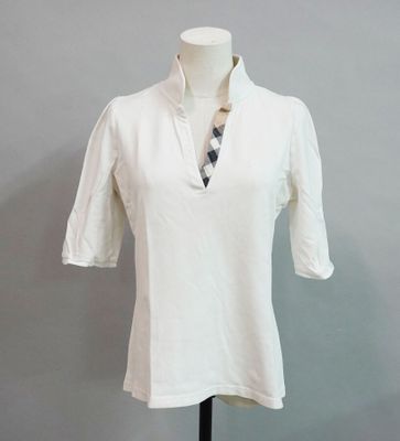 a white shirt with a checkered tie on a mannequin