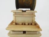 a small wooden box with a spool on top of it