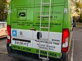 a green van that is parked in the parking lot