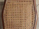 a close up of a wooden chair on a wooden floor