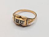 an image of a gold ring with a cassette player on it